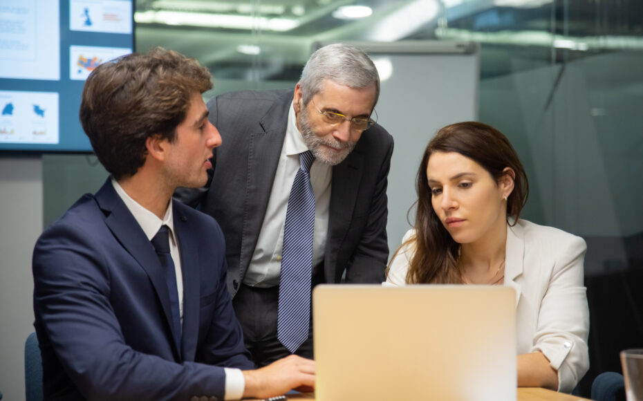 front-view-confident-business-team-looking-laptop