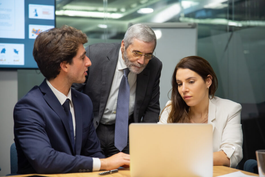 front-view-confident-business-team-looking-laptop