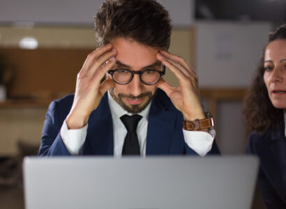 front-view-tired-man-eyeglasses-looking-laptop